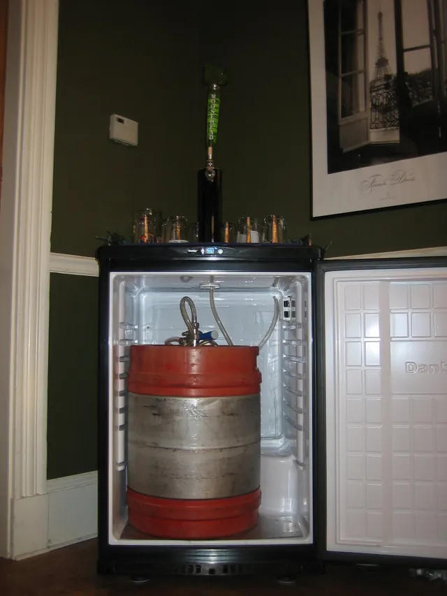 Compact refrigerator set up as a kegerator