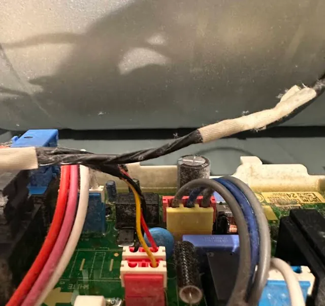 Technician testing an appliance control board